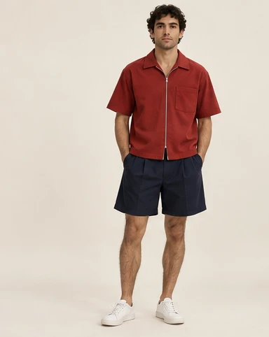 AI-generated independent concept, look 05: Brick zip shirt · navy pleated short, front view.